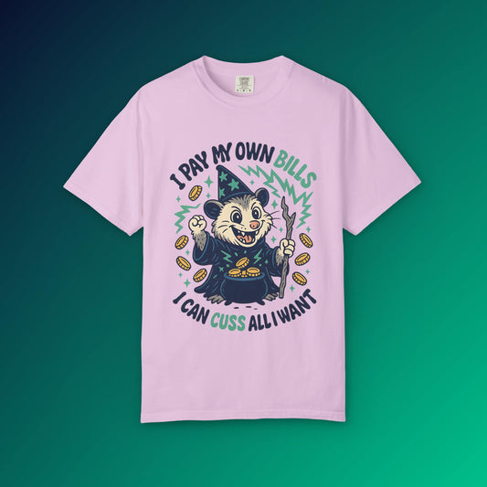 Pink t-shirt featuring a cartoon possum wizard holding a staff with funny text about paying bills