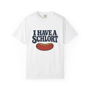 A white short-sleeve crewneck t-shirt featuring a graphic print of a hot dog under the text 'I HAVE A SCHLORT' in dark navy blue letters.