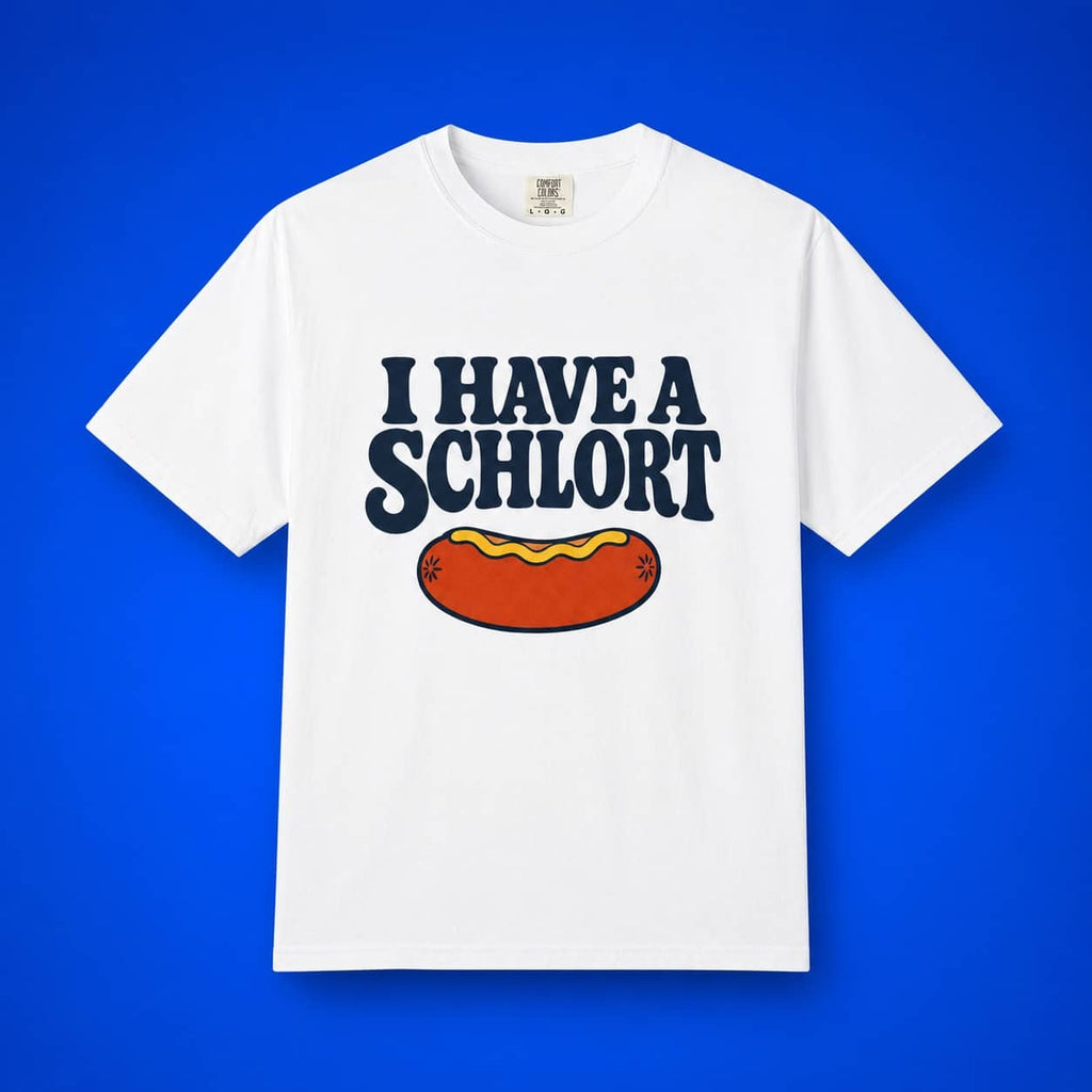 A white short-sleeve crewneck t-shirt featuring a graphic print that reads 'I HAVE A SCHLOTRT' in dark navy blue letters above a cartoon hot dog with mustard, displayed against a solid blue background.