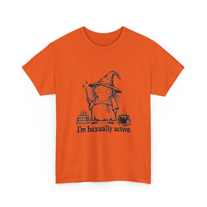 An orange short-sleeve crewneck t-shirt featuring a black graphic of a wizard character and the text 'I'm hexually active.' printed on the front, displayed against a solid white background.