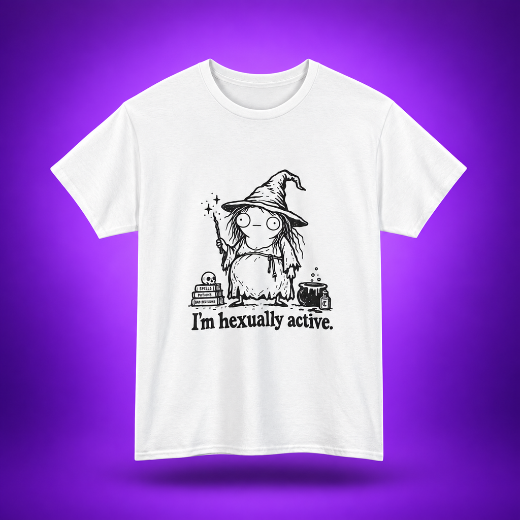 A white short-sleeve crewneck t-shirt featuring a black cartoon graphic of a witch with the text 'I'm hexually active.' printed on the front, set against a purple gradient background.