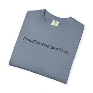 A folded blue-grey T-shirt with the [Inaudible Nerd Breathing] text design centered in the middle