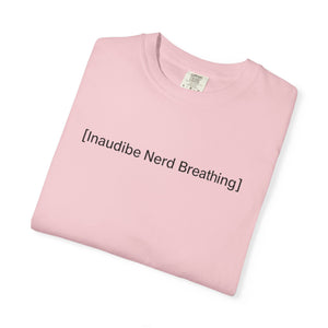A neatly folded light pink T-shirt displaying the [Inaudible Nerd Breathing] meme print