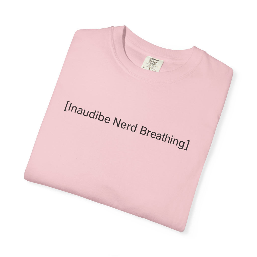 A neatly folded light pink T-shirt displaying the [Inaudible Nerd Breathing] meme print