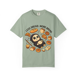 Sage green t-shirt flat lay with cute reaper eating a croissant.