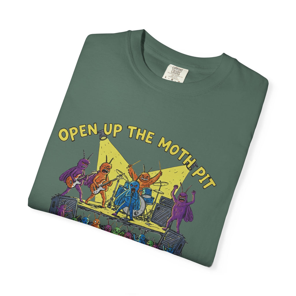 A dark spruce green Comfort Colors t-shirt folded flat, centered on the "Open Up The Moth Pit" graphic which depicts a rowdy moth concert with a glowing lightbulb centerpiece.