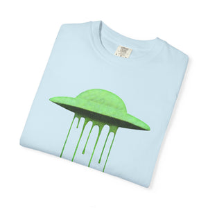 A folded light blue Comfort Colors t-shirt with a neon green dripping UFO design on the front