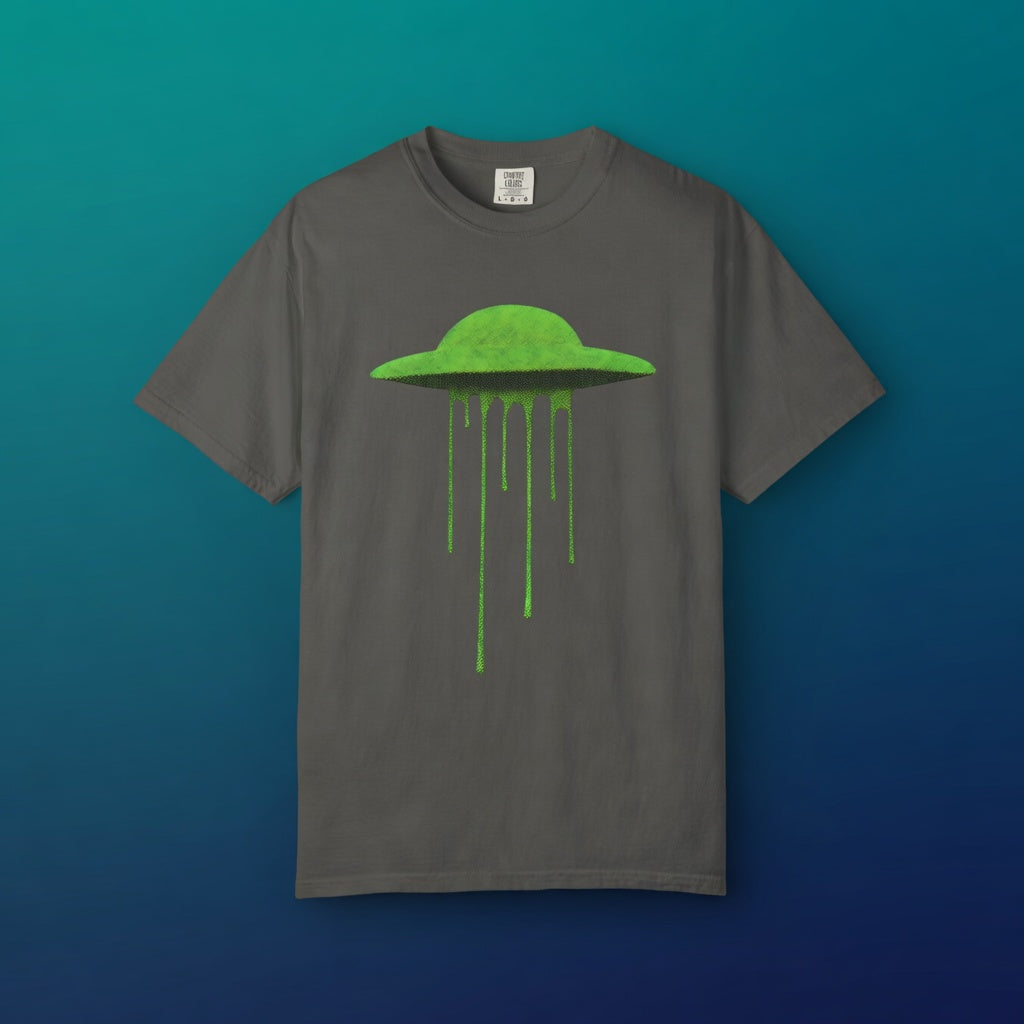 Neon Slime UFO tee centered against a vibrant teal and blue gradient background, showcasing the popping contrast of the slime alien graphic