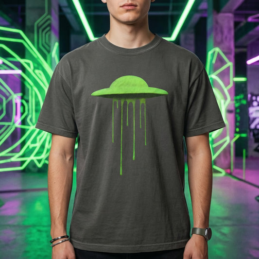 Neon Slime UFO tee centered against a vibrant teal and blue gradient background, showcasing the popping contrast of the slime alien graphic