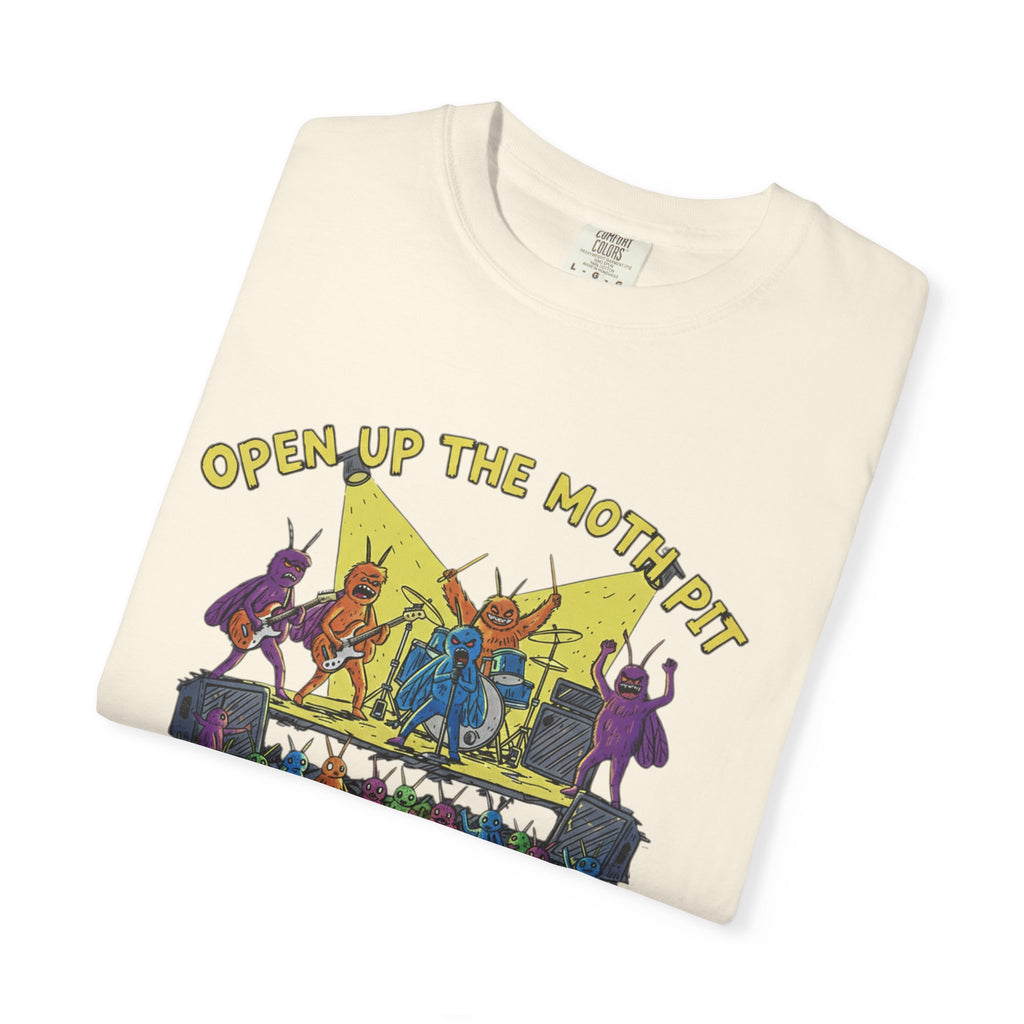 An ivory or cream-colored Comfort Colors t-shirt folded to show the "Open Up The Moth Pit" band graphic, featuring purple, orange, and blue moth characters rocking out on stage.