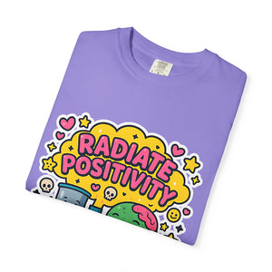 Folded purple t-shirt showing close-up of Radiate Positivity typography and zombie brain.