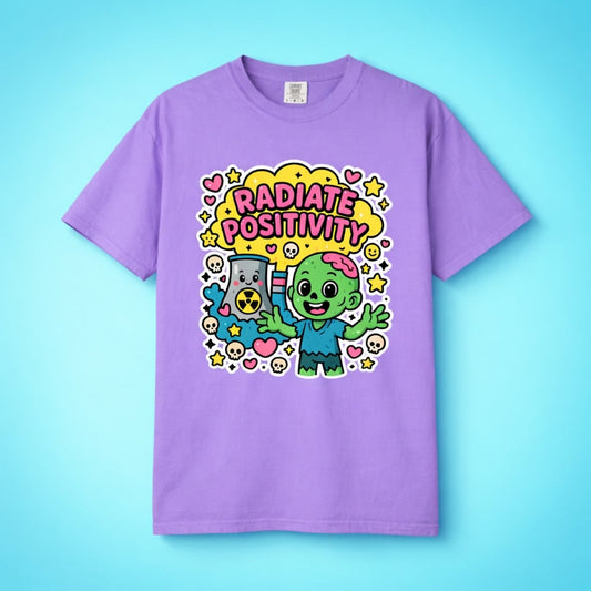 Flat lay of a purple Radiate Positivity shirt featuring a happy nuclear cooling tower and zombie.