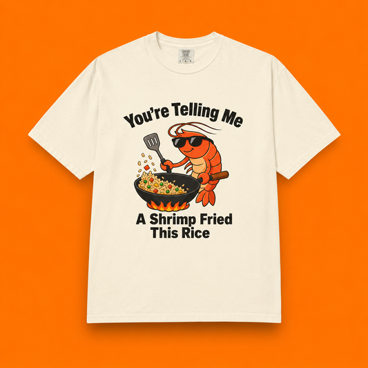 Ivory graphic t-shirt flat lay on orange background featuring shrimp fried rice design. 