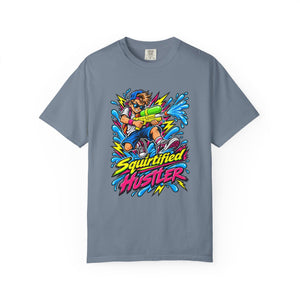 A slate blue crewneck t-shirt featuring a colorful graphic of a cartoon character holding a water gun, surrounded by blue water splashes and the text 'Squirtified HUSTLER' in yellow and pink.