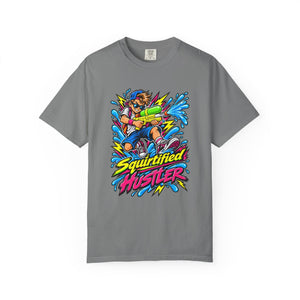 A gray short-sleeve crewneck t-shirt featuring a colorful graphic of a cartoon character holding a water gun, surrounded by blue water splashes and the text 'Squirtified HUSTLER' in yellow and pink.