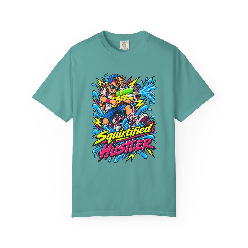 A teal short-sleeve crewneck t-shirt featuring a colorful graphic of a person holding a water gun with the text 'Squirtified HUSTLER' in a bold, graffiti-style font.
