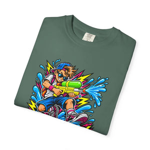 A dark green folded t-shirt with a colorful cartoon graphic of a boy playing with a water gun, shown on a plain white background.