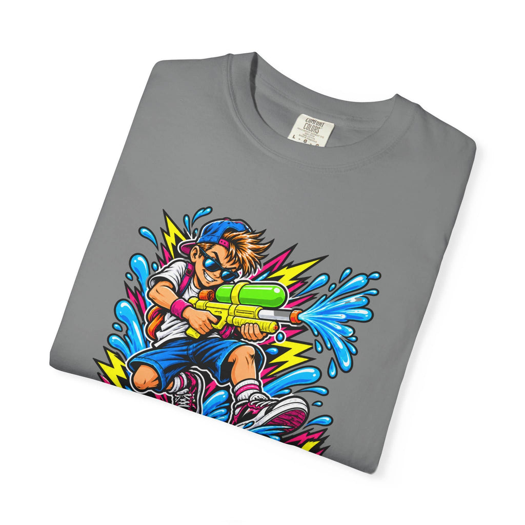 A folded gray crewneck t-shirt featuring a colorful graphic print of a cartoon boy holding a green and yellow water gun with blue splashes and lightning bolts.
