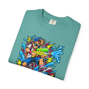 A folded teal t-shirt with a colorful cartoon graphic of a boy holding a water gun, shown on a plain white background.