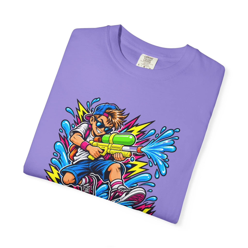 A folded purple crewneck t-shirt with a colorful cartoon graphic of a boy holding a water gun, shown on a plain white background.