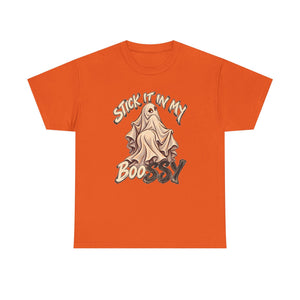 An orange short-sleeve crewneck t-shirt featuring a graphic of a ghostly figure draped in a sheet with the text 'STICK IT IN MY BOOSSY' in stylized lettering.