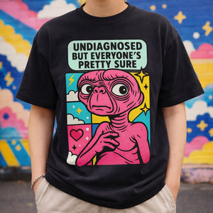 Model wearing the "Undiagnosed But Everyone's Pretty Sure" black t-shirt, street style look.