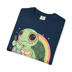 Flat lay of a folded Navy Blue Comfort Colors t-shirt featuring a cartoon turtle holding a knife with a rainbow background.