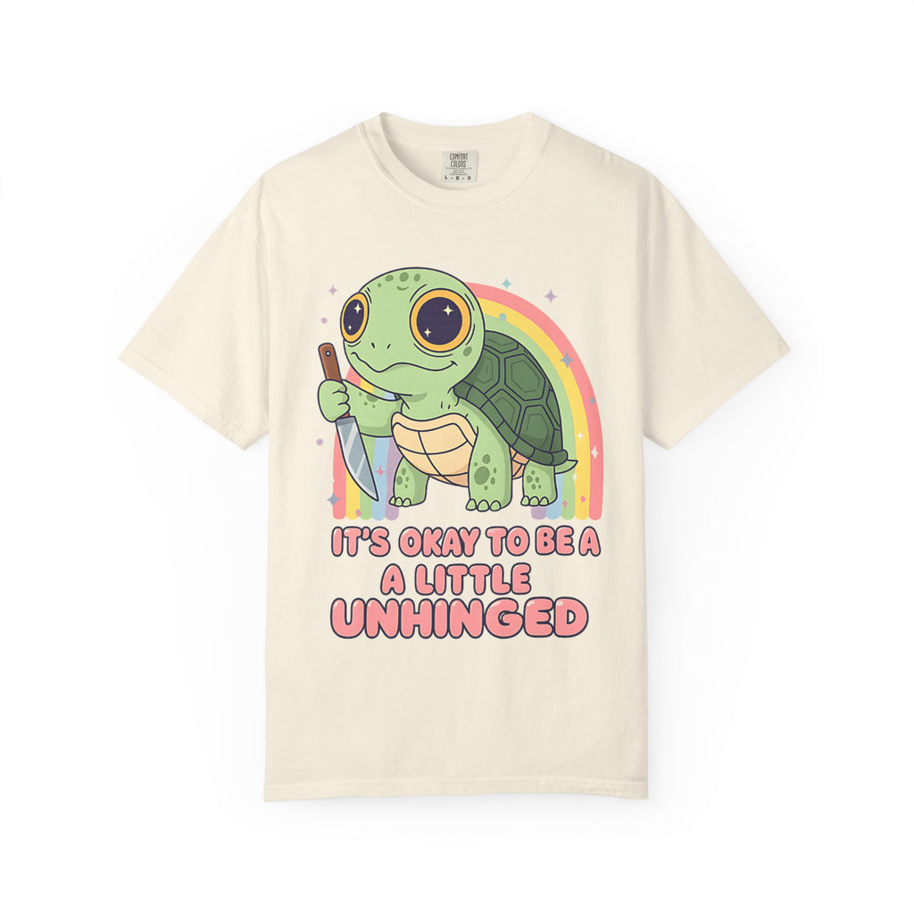 Ivory t-shirt featuring a cute green turtle holding a knife with the text "It's Okay To Be A Little Unhinged".