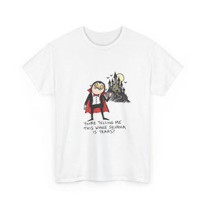 A white short-sleeve crewneck t-shirt featuring a cartoon graphic of a trans vampire character standing in front of a haunted castle under a full moon, with the text 'YOURE TELLING ME THIS WHERE SEWANA IS TRANS?' printed below.
